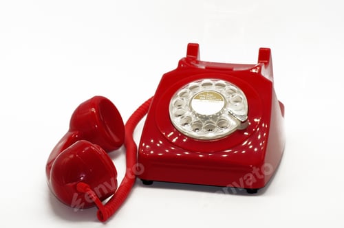 Preview: Closeup shot of a red vintage phone isolated on a white background