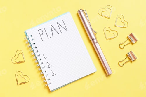 Preview: Inscription Plan in a blank notepad and stationery on yellow background copy space.