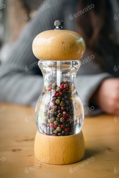 Preview: Close up, bottle of pepper in containers with grinder.