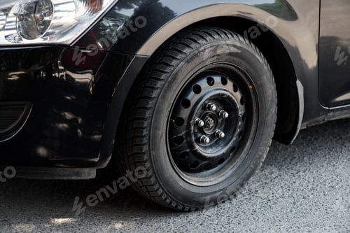 Preview: The image in front of the black car's wheel