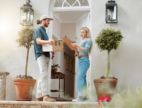 Preview: Same-day delivery is such a blessing. Shot of a customer signing for her delivery from the courier.