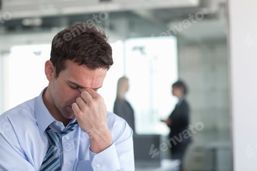 Preview: Businessman in distress in an office setting