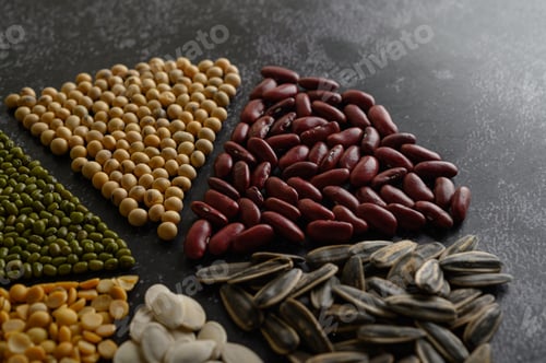Preview: Legumes arranged in a circle on the black cement floor.