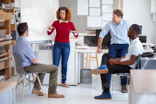 Preview: Getting input from the crew. Shot of a group of designers talking together in a presentation.