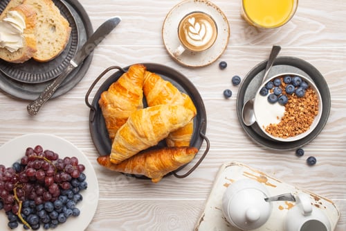 Preview: morning breakfast with fresh croissants, granola with yoghurt and berries, toasts, coffee