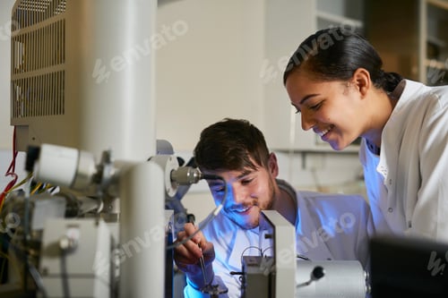 Preview: Scientists in laboratory using scientific equipment smiling