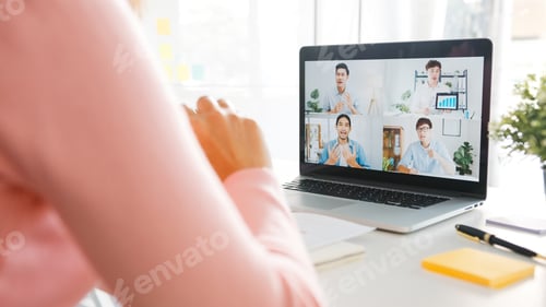 Preview: Young Asia businesswoman using laptop talk to colleague in video call meeting while work from home.