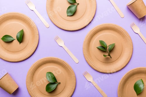 Preview: set of empty reusable disposable eco-friendly plates, cups, utensils on light white colored table