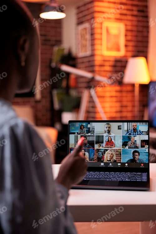 Preview: Businesswoman chatting with remote team on teleconference using laptop