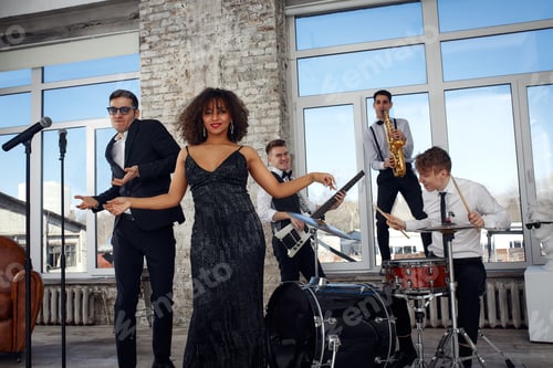 Preview: Repetition of multi ethnic jazz band in loft. Bass guitar player, electric guitar player