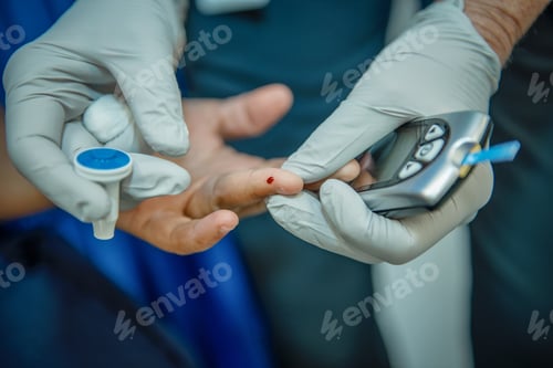 Preview: A medical professional checking a patients blood sugar.