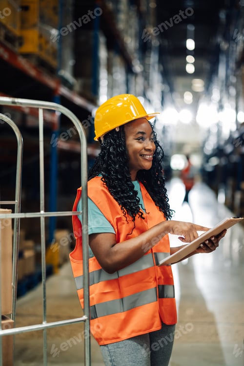 Preview: Female worker using digital tablet checking inventory in warehouse