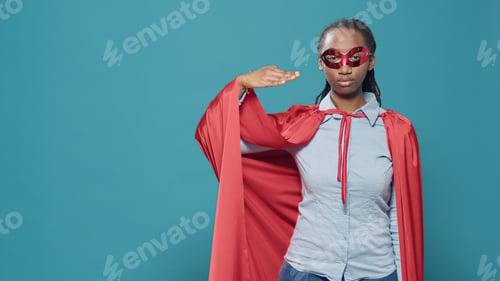 Preview: Portrait of woman superhero doing military salute