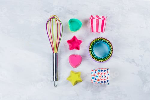Preview: Colorful Rainbow Kitchen utensils for bakery on white marble table background. Top view