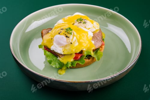 Preview: Tasty egg Benedict on green plate