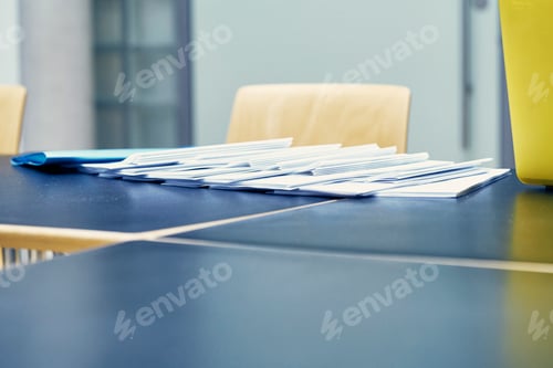 Preview: Row of paperwork on boardroom table