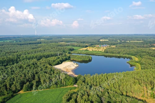 Preview: Tranquil lake surrounded by lush green grass in a picturesque outdoor setting