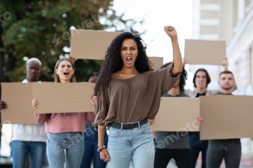 Preview: Young woman leading a group of demonstrators on the street