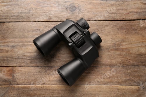 Preview: Modern binoculars on wooden table, top view