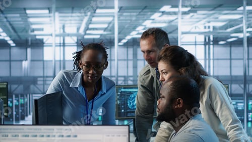 Preview: Multiethnic team of engineers working in high tech server hub,