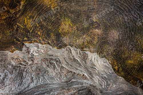 Preview: Top view of the water of a river and a rock bank. The wind gives the whole a superb texture.