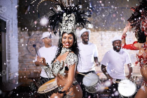 Preview: Performing a live show. Shot of two female dancers with their band in the background.