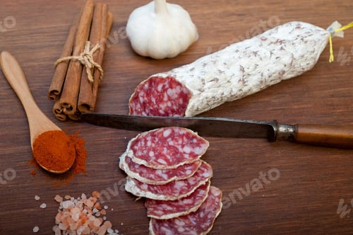 Preview: traditional Italian salame cured sausage sliced on a wood board