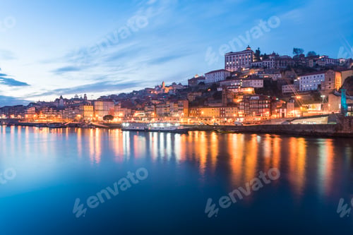 Preview: Portugal, Porto, Duoro river and old town buildings illuminated at dusk