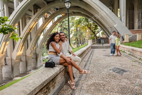 Preview: Happy couple enjoying urban architecture and green park