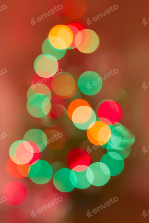 Preview: Blurred garland on Christmas tree. Abstract pattern. Defocused background.
