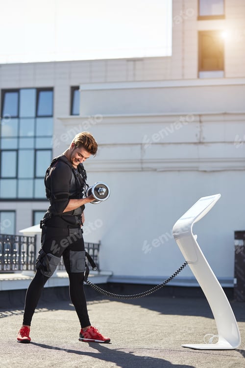 Preview: fit positive guy in EMS suit enjoying his workout