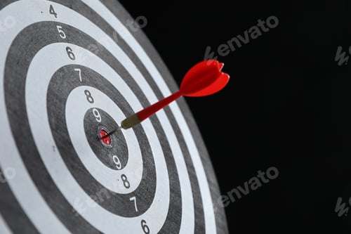 Preview: Targeting. Dart board with arrow on black background, closeup