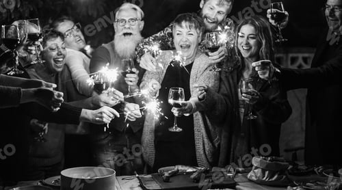 Visualização: Grupo de amigos comemorando juntos a véspera de ano novo após o jantar em casa