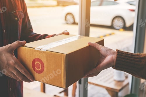 Preview: woman receiving parcel box from delivery man at the house's door