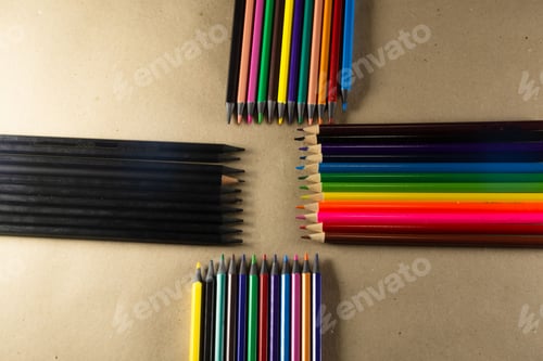 Preview: Vibrant assortment of colored pencils laid out on a wooden table