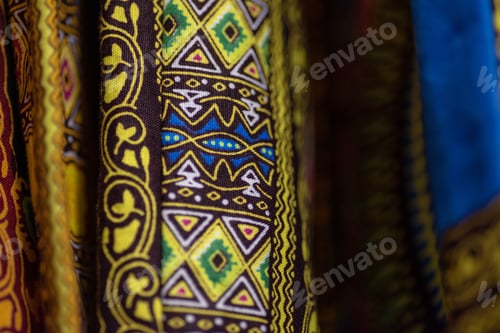 Preview: Close up shot of kente fabric hanging on railing
