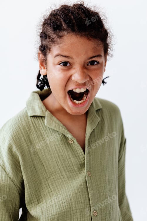 Preview: Young african american boy expressing surprise and wonder with mouth open against a clean white