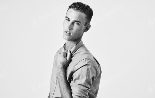 Preview: Portrait of a handsome guy in a shirt on a light background close-up portrait