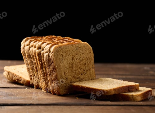 Preview: Sliced wheat flour bread on a wooden board. Sandwich bread
