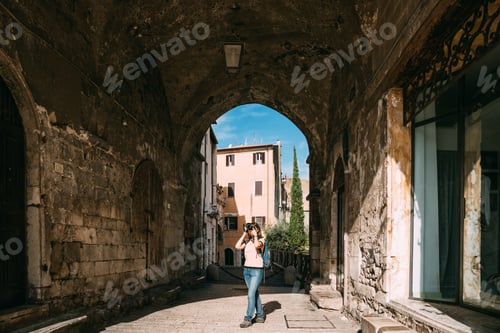 Preview: Terracina, Italy. Young Caucasian Woman Taking Photos In Gothic