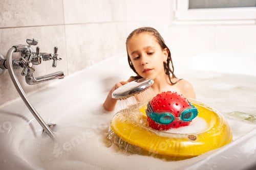 Preview: Funny little unidentified girl showering a head made of a ball