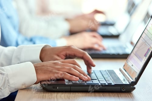 Preview: Black man's hands typing on laptop.