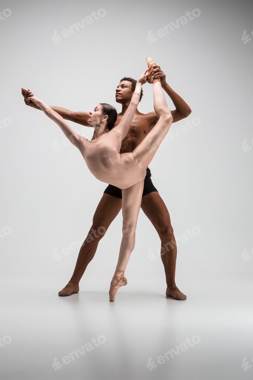 Preview: Couple of ballet dancers posing over gray background