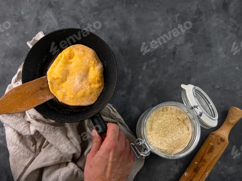 Preview: Homemade corn flatbread meal frying pan in male hand Handmade mexican tortilla wrapping latin recipe