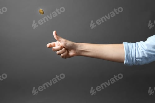 Preview: Young woman throwing coin on grey background, closeup