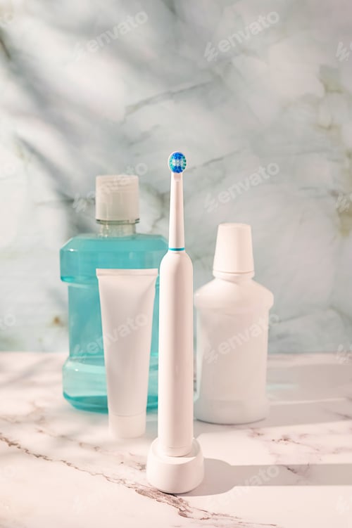 Preview: Morning oral hygiene routine, toothbrush,electric toothbrush, floss, toothpaste tube and mouthwash.