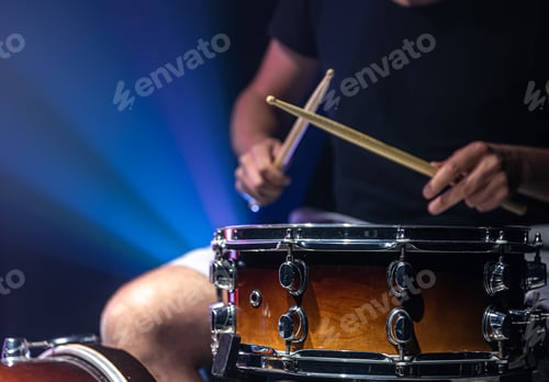 Preview: Close-up shot of a drummer playing a snare drum with sticks.
