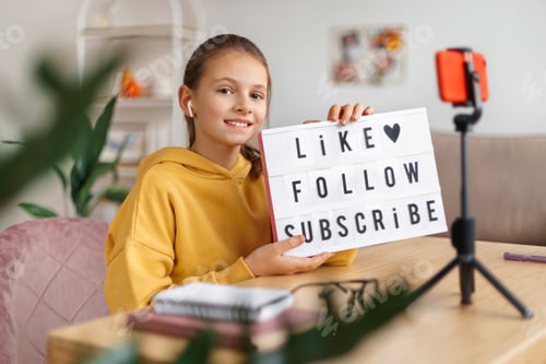 Preview: Smiling blogger girl recording vlog at home
