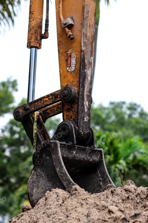 Preview: Vertical shot of excavator bucket in the ground