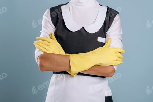 Preview: Hands in yellow gloves, maid is ready for work. Woman is in the studio against background